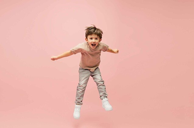 Happy caucasian little boy isolated on pink studio background. Looks happy, cheerful, sincere. Copyspace. Childhood, education, emotions concept